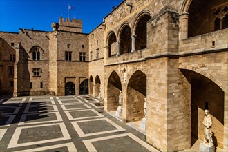 Inner courtyard surrounded by arcades with statues from Hellenistic and Roman times, Grand Masters Palace built in the 14th century by the Johnnite Order, fortress and palace for the Grand Master, UNE...