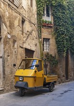 Three-wheeler in the streets of Pitigliano old town, Tuscany, Italy, Europe