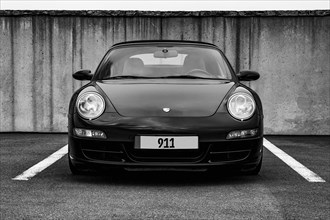 Black and white photo front view of sports car black Porsche 911 997 1st generation, Germany, Europe