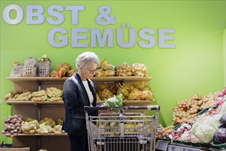 Older woman buys a cauliflower in the supermarket, Radevormwald, Germany, Europe