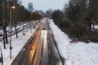 Snow in Duesseldorf, Kennedydamm, road conditions, little traffic, cautious driving, winter, overfrozen wetness, slippery snow, ruts, Duesseldorf, North Rhine-Westphalia, Germany, Europe