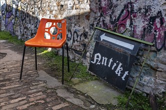 Plastic chair in orange, RAW site, former Reichsbahn repair works, Friedrichshain, Berlin, Germany, Europe