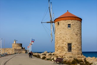 Three windmills on the pier with Agios Nikolaos fortress, Mandraki harbour, Rhodes Town, Greece, Europe