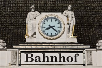Ironworker and miner next to the station clock on the roof at the main station, Hamm, Ruhr area, North Rhine-Westphalia, Germany, Europe