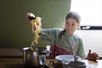 Ten year old girl with spaghetti, Bonn, Germany, Europe