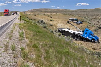 Diamondville, Wyoming, A semi-trailer truck that drove off U.S. Highway 30 and overturned in southwestern Wyoming