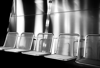 Black and white photograph, chrome seats on a platform, Berlin, Germany, Europe