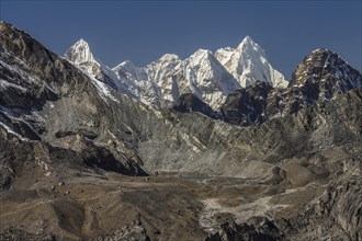 View towards the West from Chukhung Ri, a trekking peak in the Imja Khola valley. Kongma La is in the view, the lowest point on the ridge above the visible lake. Left of it, the ridge rises towards Po...