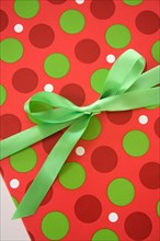 Colorful gift box with green satin bow