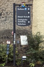 Information signs in the medieval town centre of Hillesheim, with a fortified defence tower of the 13th century town fortifications, Hillesheim, Rhineland-Palatinate, Germany, Europe
