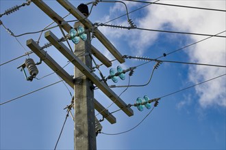 Concrete electricity poles with porcelain and glass insulators