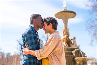 Couple of multi-ethnic men in a city fountain