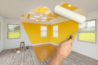 Before and after of man using A paint roller to reveal newly remodeled room with fresh yellow paint