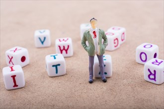 Figurine standing in front of the colorful alphabet letter cubes