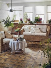 Living room with wicker furniture and houseplants