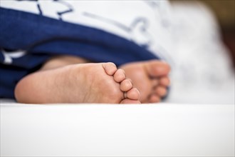Childrens feet in bed