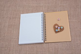 Colorful cubes with a heart on notebook on canvas