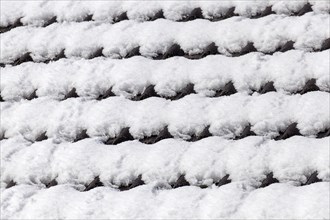 Snowy roof tiles on a roof in winter
