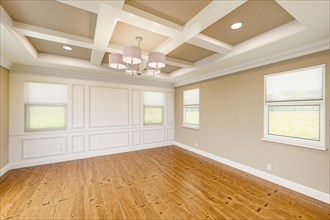 Beautiful tan custom master bedroom complete with entire wainscoting wall