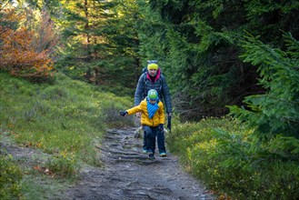 Mum and child are walking along the mountain hiking trail. Family spending time. Polish mountains