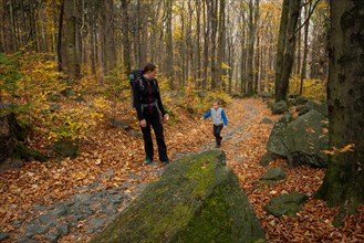 Mum and child are walking along the mountain hiking trail. Family spending time. Polish mountains