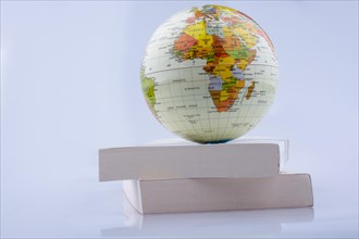 Little model globe put on a white boxes on a white background