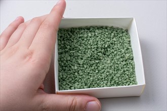 Little green color sand in box as a background texture