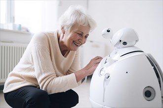 An elderly woman in a retirement home has fun with a care robot