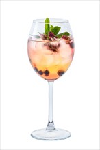 Cold white sangria with dry rosebuds in wine glass isolated on white background