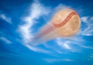 Baseball flying through the air and blue sky