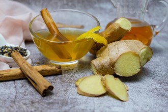 Jar of fresh ginger tea with lemon and cinnamon