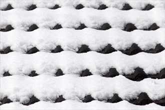 Snowy roof tiles on a roof in winter