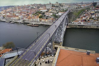 View of the Dom Luis I bridge over Douro River and terracota rooftops