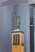 Church in front of a high-rise building in Frankfurt
