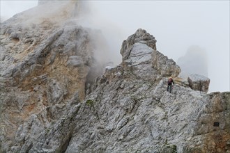 Tourist with equipment on the via ferrata trail in the alps. Dolomites