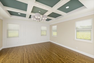 Beautiful muted teal and tan custom master bedroom complete with entire wainscoting wall