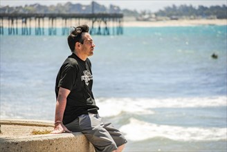 A man looking the ocean near Ventura Pier