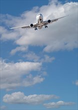 Passenger airplane in approach for landing with beautiful blue sky