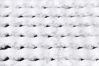 Snowy roof tiles on a roof in winter