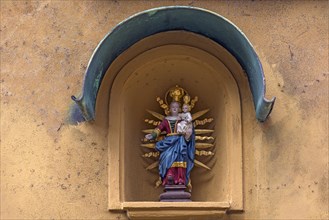 Sculpture of Mary with the Child Jesus in a niche on a residential house