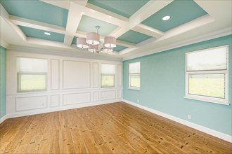 Beautiful light blue custom master bedroom complete with entire wainscoting wall