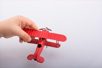Child holding a little metal model airplane in hand