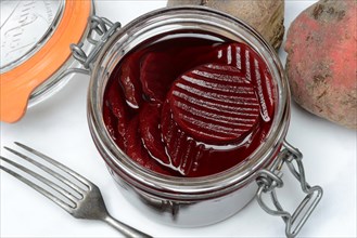 Pickled beetroot in glass jar and beetroot