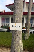 A sign saying Private was nailed to a tree trunk as a hint