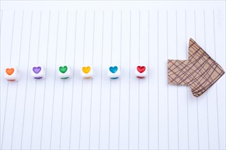 Love cubes and paper arrow on a notebook