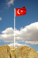 Turkish national flag on a rock in open air