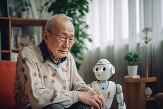 An elderly Asian man in a retirement home has fun with a nursing robot