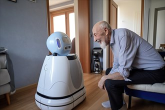 An elderly man in a retirement home has fun with a sweeping robot