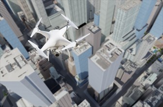Unmanned aircraft system quadcopter drone in the air above city and corporate buildings