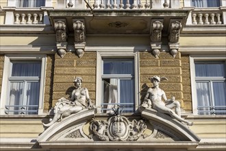 Detail with sculptures of a naked woman and a man above the entrance to the Hotel Continental